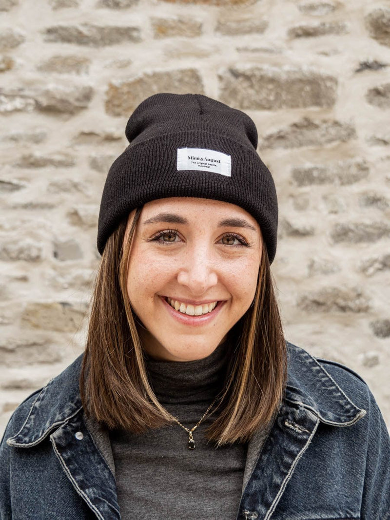 woman smiling and wearing the intemporel black beanie