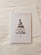 Minimal Christmas tree greeting card on recycled matte cardstock with white envelope and compostable packaging