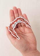 Hand holding Montreal is Mimi vinyl sticker with flower arch design and white border