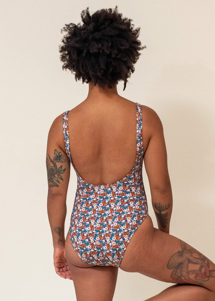 Back of aline wearing the floral bouquet one piece bathing suit
